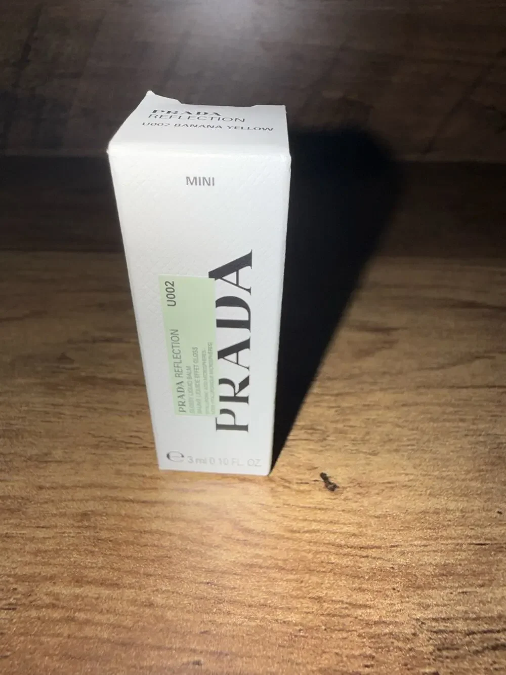 Prada Reflection Glossy Lip Balm in shade U002 Banana Yellow